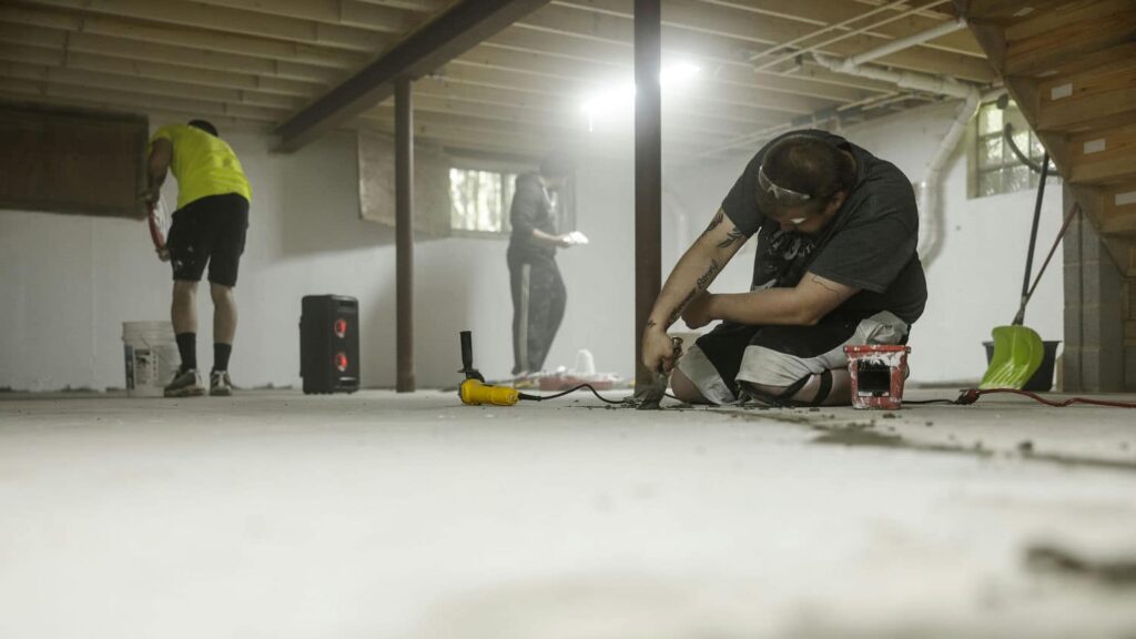 basement renovation experts fixing uneven floor and waterproofing
