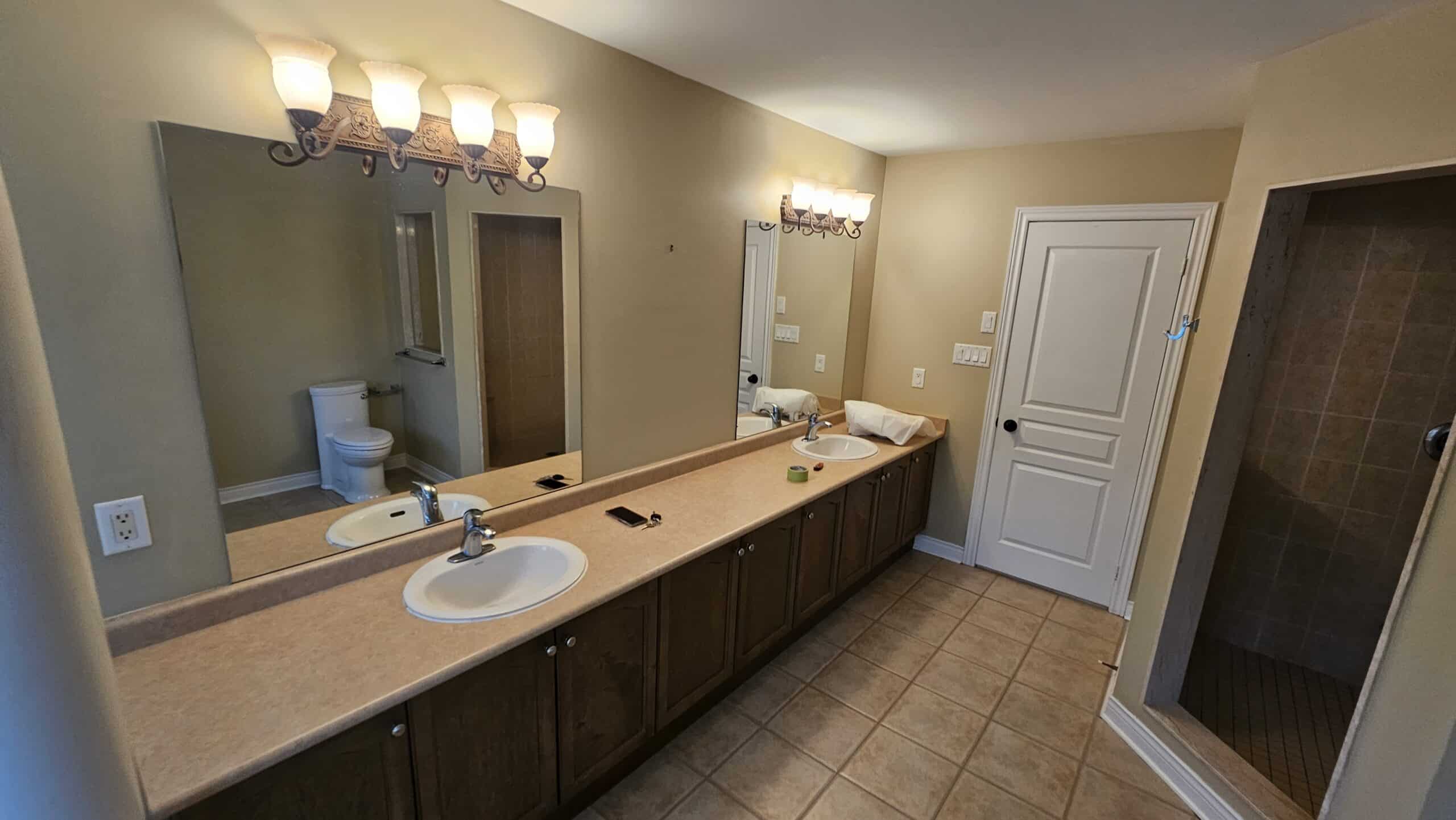 laminate counter tops with old drop in sinks and out of date tiles on the floor