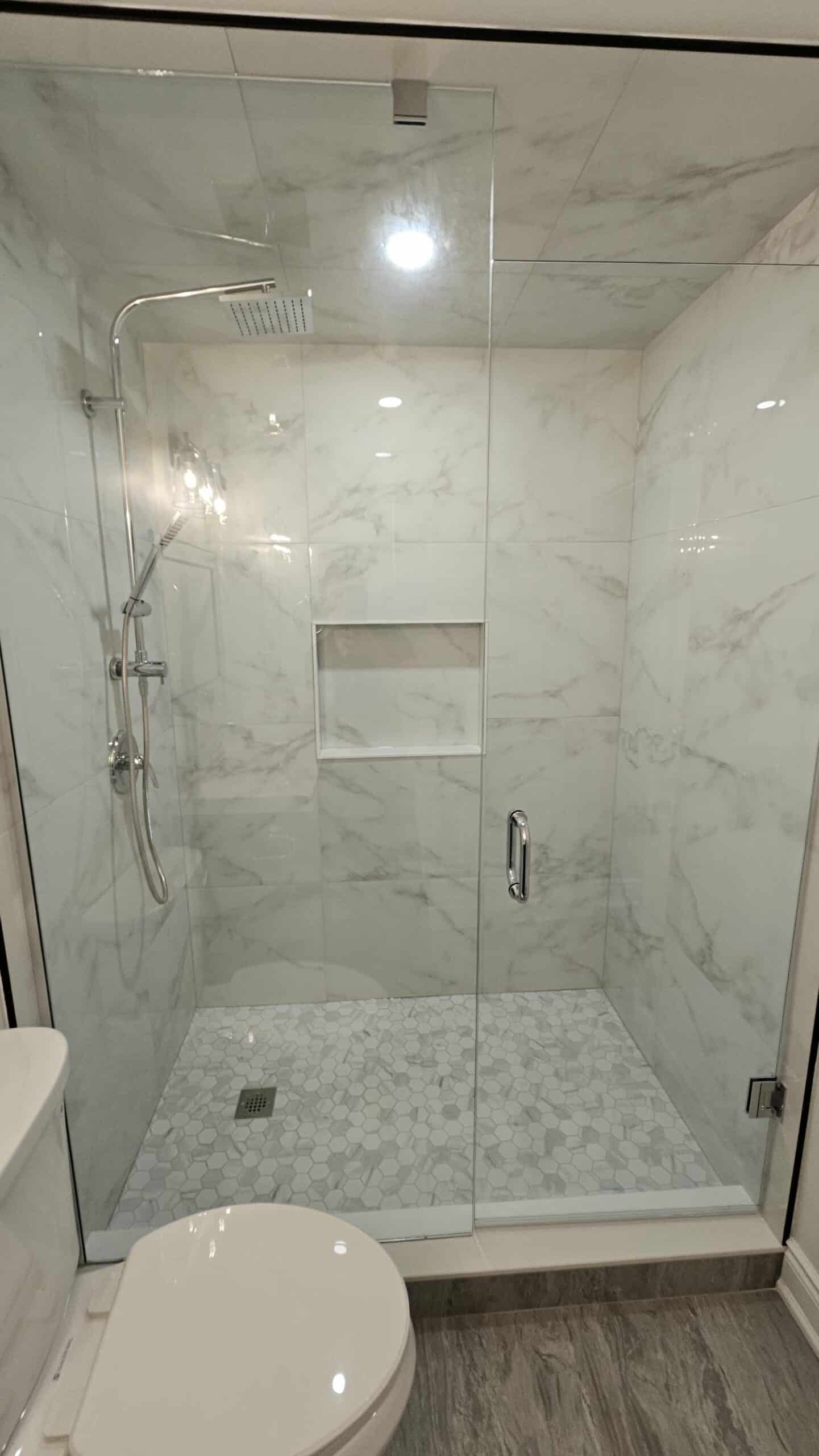 glass shower in the bathroom with chrome hardware finishes