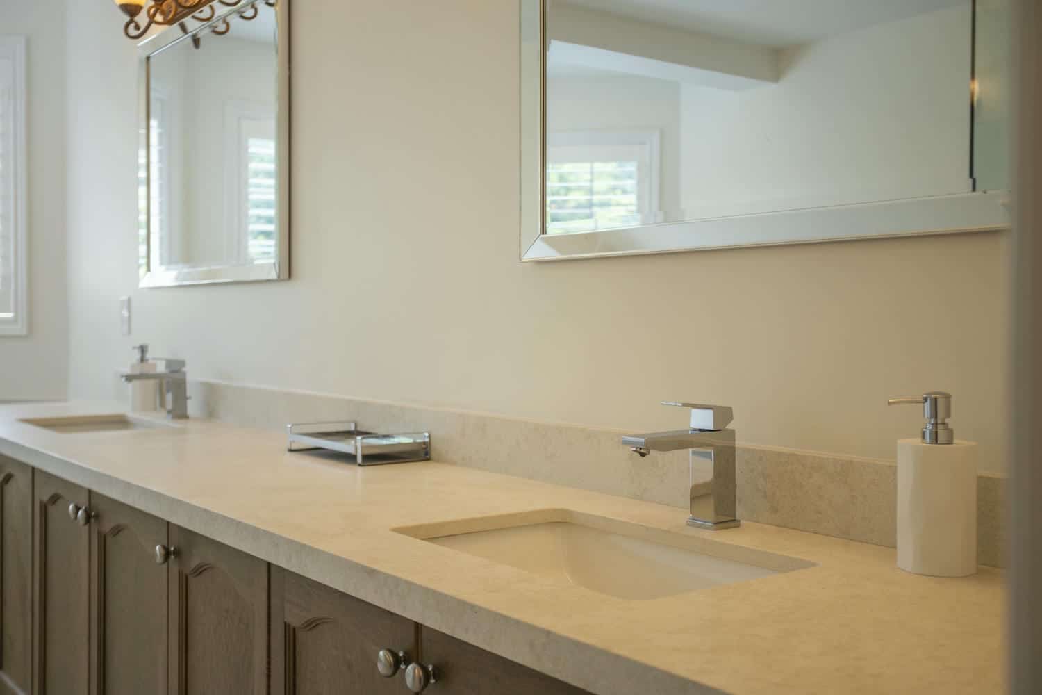 chrome faucets with 2 large mirrors and 2 soap dispensers