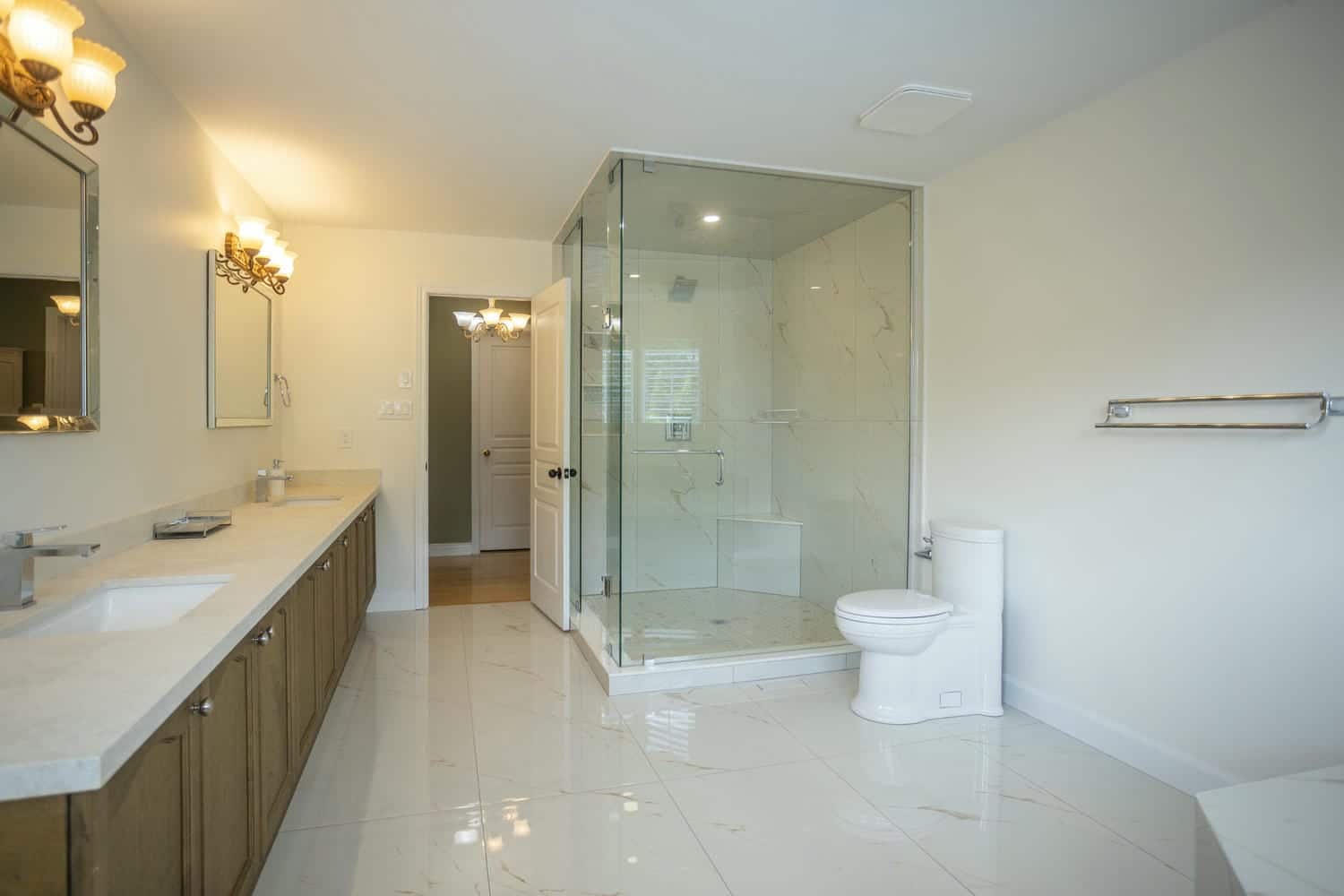 one piece toilet sitting on large format glossy tile