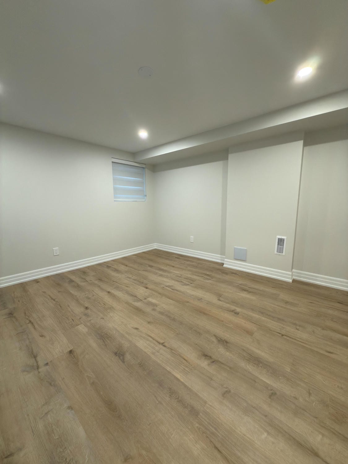 Clean, open room with a warm wood finish. Perfect space for a bedroom, office, or lounge area