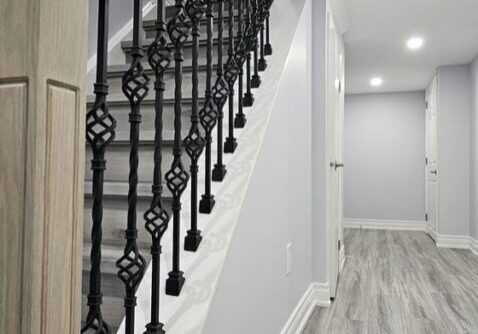 Custom vinyl steps and Oak railings with iron spindles
